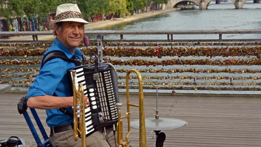 Paris France - July 26 2013: One Man Band Entertains tourists on the Pont Des Arts bridge Paris France.